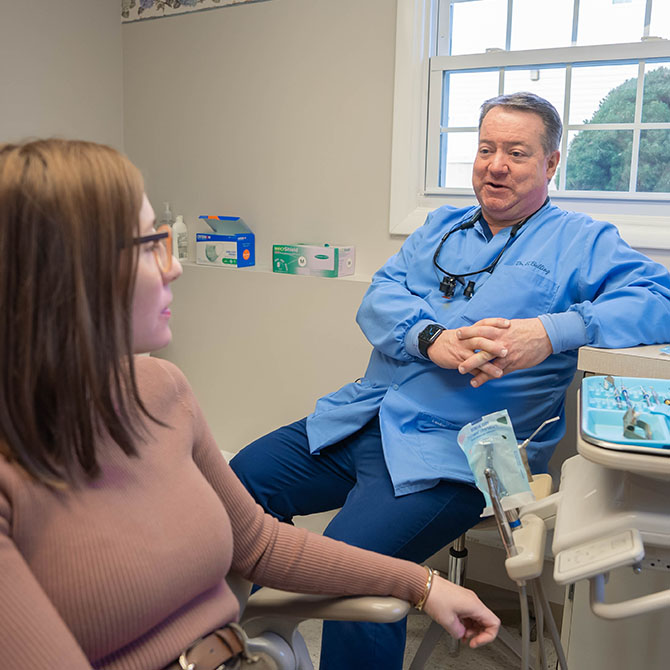 Dr. Edward J. Balling talking to a patient inside the clinic